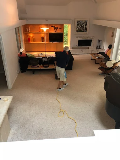 Pure Carpet Cleaners technician deep-cleaning the carpet of a large Atlanta living room