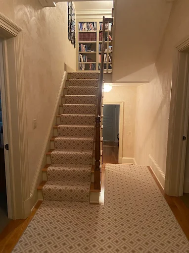 Cleaned geometric-pattern stair runner and matching hallway runner in an Atlanta home